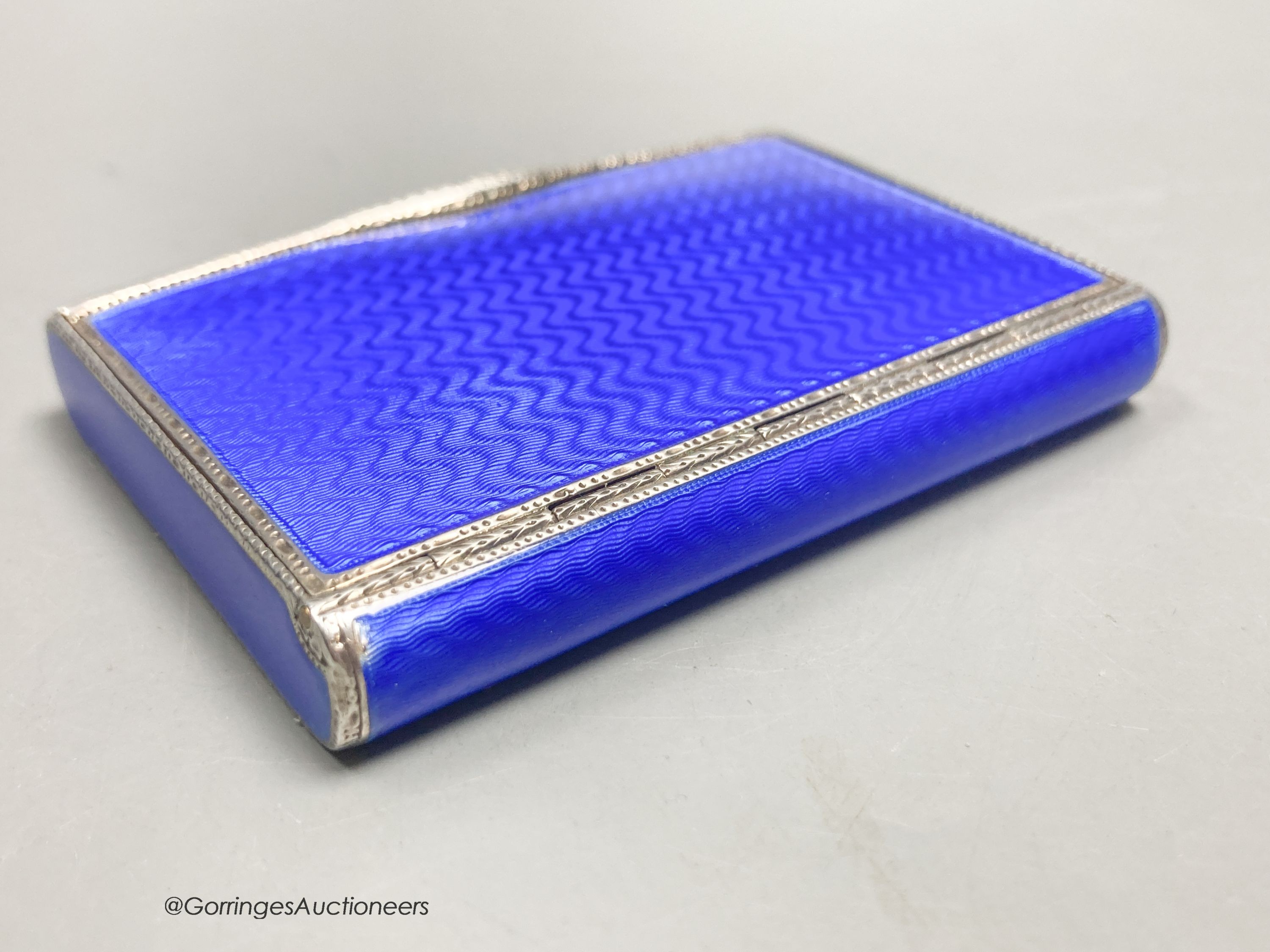 A 1920's continental silver and blue guilloche enamel rectangular box with hinged cover, import marks for DC, London, 1927, 77mm by 55mm by 12mm